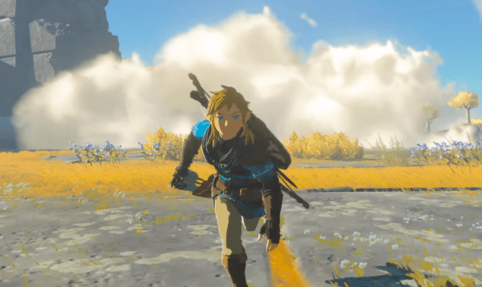 Obrazek przedstawia biegnącego Linka z gry The Legend of Zelda: Tears of the Kingdom na tle chmury po kamieniach